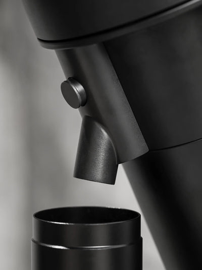 Close-up of the WPM ZP1 Single Dose Grinder's dosing spout and hopper design.